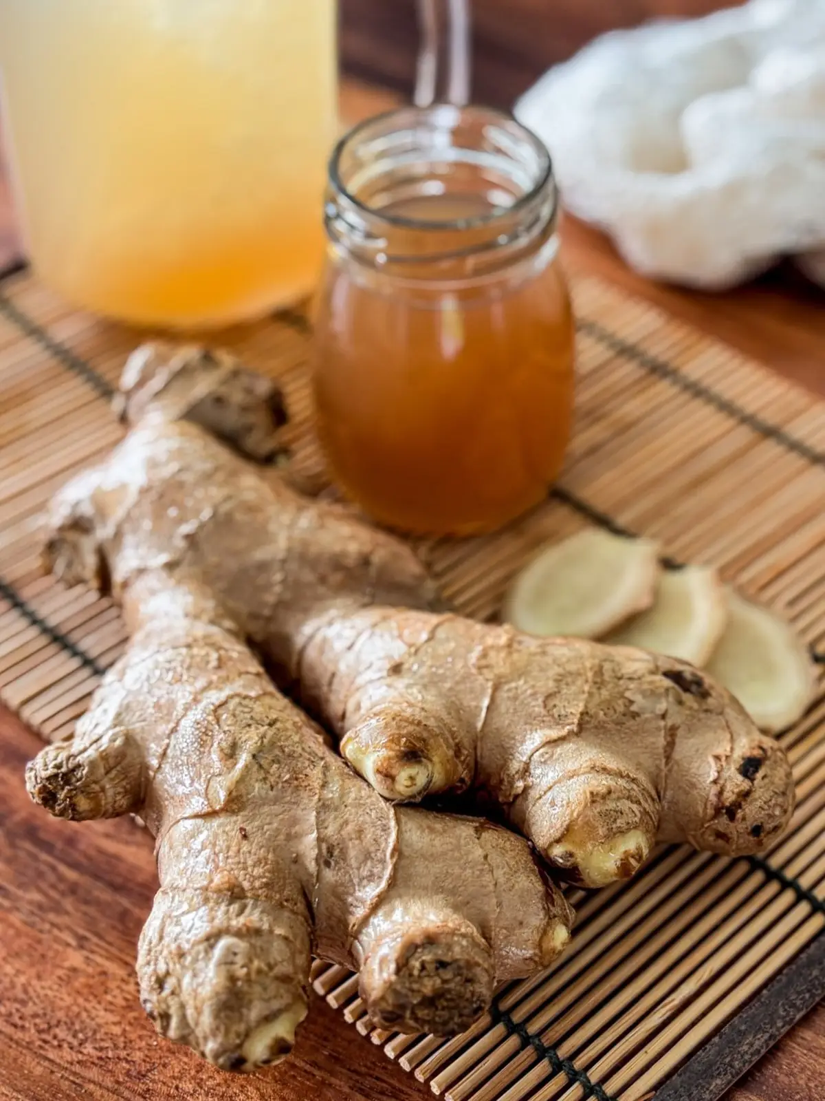 Homemade ginger simple syrup with fresh ginger root and sliced ginger.