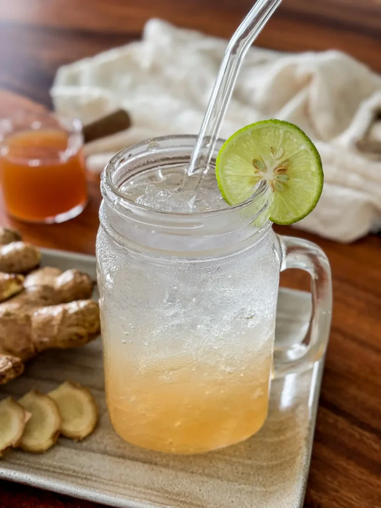 Homemade ginger soda with ice and fresh lime.