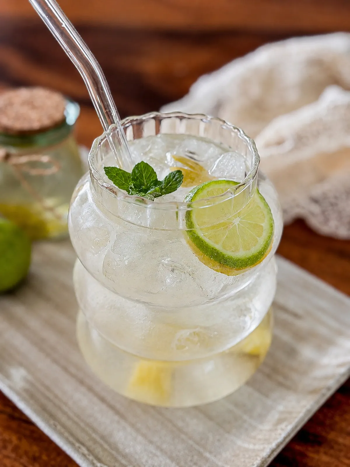 Lime syrup soda with ice, fresh lime, and mint.