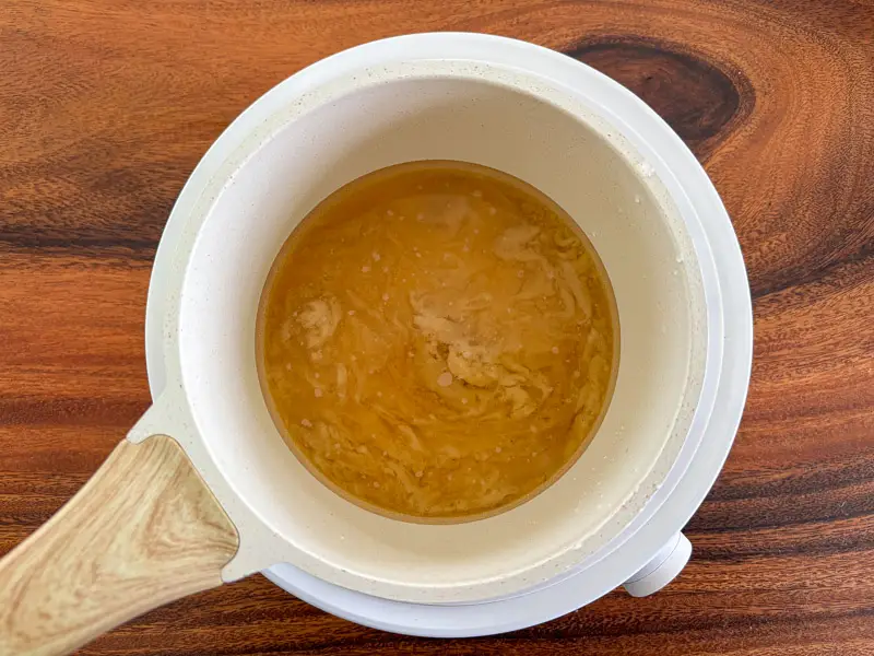 Palm sugar melting in a saucepan.