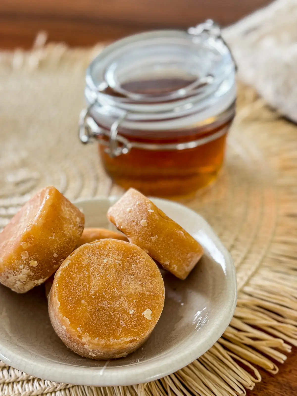 Homemade palm sugar syrup served with pieces of Thai palm sugar.